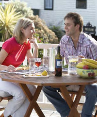 A couple enjoying a meal on their new Garden Decking